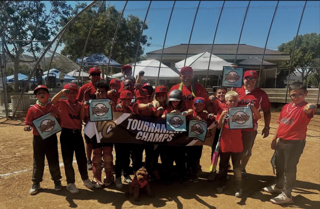 Rage Baseball players holding Velo City Tournament Champions banner and signs